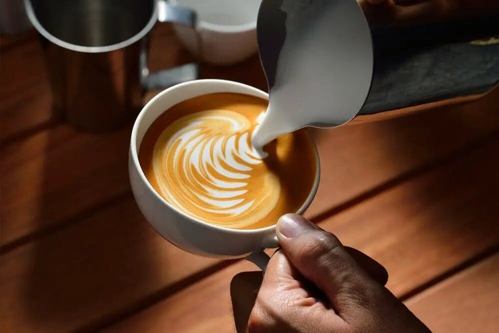 How do you use a Nespresso milk frother for a latte?